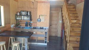 a kitchen with a sink and a staircase in a cabin at Cabaña Valdivia Piedra Blanca 2 in Valdivia
