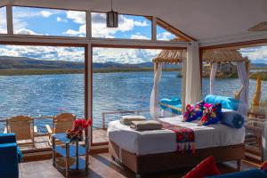 a bedroom on a boat with a view of the water at TITICACA FLAMENCO LODGE in Puno