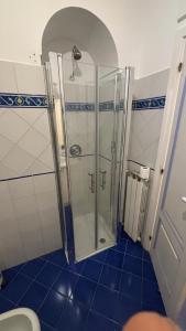 a shower with a glass door in a bathroom at Villa Piccinina A pochi passi da Villa Eva in Ravello