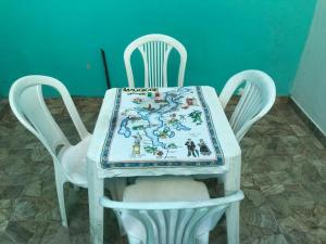 a table with a table cloth on top of two chairs at Carnaval Inn Salvador in Salvador