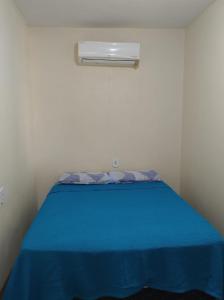 een kleine slaapkamer met een blauw bed en een raam bij Apt mar de são josé in São José da Coroa Grande