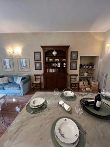 a living room with a table with plates and wine glasses at Maestra Exclusive Chianti House, Tuscany in Poggibonsi