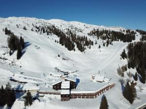 a ski lodge in the snow on a mountain at Casa Pisolo - presso Sussy Residence in Falcade