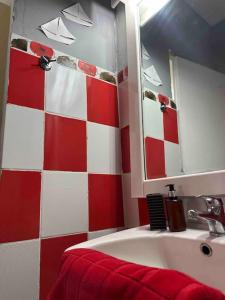 a red and white bathroom with a sink and a mirror at Chouliarades Tzoumerka in Chouliarades +43 photos