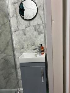 a bathroom with a sink and a mirror at Oxborne Rooms UK - Wyatt in London