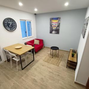 a living room with a table and a red couch at Good Vibes - Lagos Guesthouse in Lagos