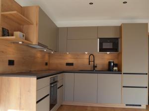 a kitchen with white cabinets and a counter top at Chalet Groissenbach in Reit im Winkl