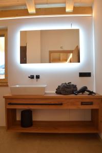 a bathroom with a sink and a mirror at Chalet Groissenbach in Reit im Winkl