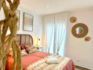 a bedroom with a large bed and a tree at Estudio con encanto en el casco, junto al puerto in Castro-Urdiales