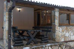 a picnic table outside of a stone building at Mountain House Skimont, Blidinje in Blidinje