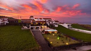 an aerial view of a house with a sunset at Casa da Belavista with Jacuzzi in Nordeste