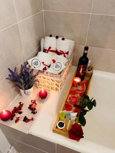 a bathtub with towels and a bottle of wine and candles at Cosy Nest Deva in Deva +58 photos