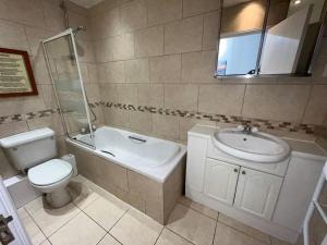 a bathroom with a toilet and a sink and a tub at Quayside City Escape - Liverpool in Liverpool