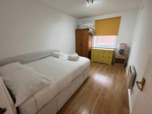 a bedroom with a white bed and a wooden floor at Quayside City Escape - Liverpool in Liverpool