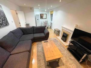 a living room with a couch and a fireplace at Quayside City Escape - Liverpool in Liverpool