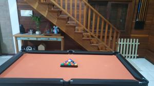 a pool table with a pile of balls on top at Rancho 3 Guri in Osório
