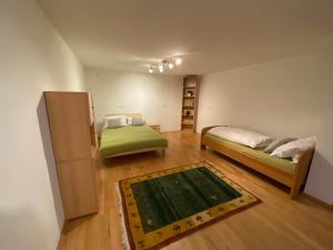 Piccola camera con 2 letti e un tappeto di Ferienwohnung Bindl a Ulrichsberg