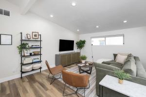 a living room with a couch and a tv at Renovated Flat near Historic 25th Street, 2BR 1BA in Ogden