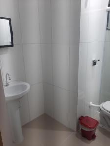 馬蒂尼奧斯的住宿－Pousada Belaisa，白色的浴室设有卫生间和水槽。