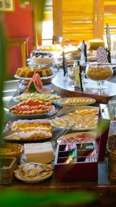 a buffet line with many different types of food at Surya-Pan Hotel Refúgio in Campos do Jordão