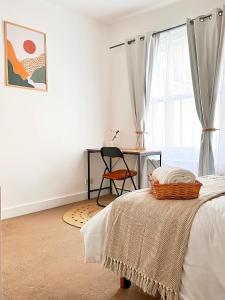 a bedroom with a bed and a chair and a window at Boho Vibe Room Centrally Located in Portsmouth City in Portsmouth