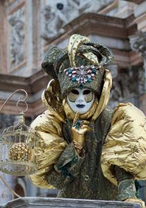 a person in a mask holding a bird cage at Casa di Ale Venezia in Mestre