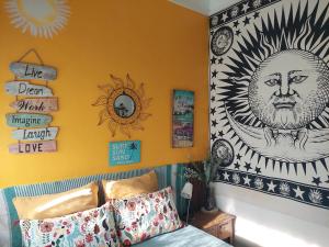 a room with a bed and a wall with pictures on it at Beach life Caparica in Costa da Caparica