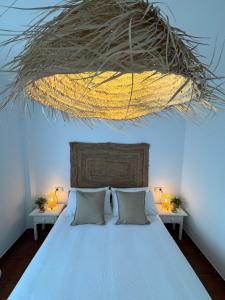 a bedroom with a large bed with two tables at Villa en Frigiliana con piscina, jacuzzi y espectaculares vistas in Frigiliana