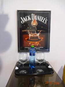 a table with two glasses and a bottle of water at Apartament Wspólna 59 Warszawa in Warsaw