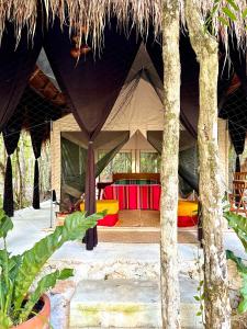 a resort with a tent with a table in it at Glamping Bunga Lotus in Tulum