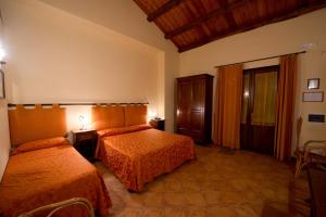 Posteľ alebo postele v izbe v ubytovaní Baglio Cudia Resort
