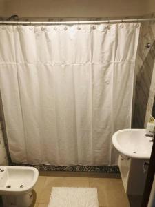 a bathroom with a shower curtain and a sink at Nuevo, acogedor y a un paso de todo!! CON COCHERA in Corrientes