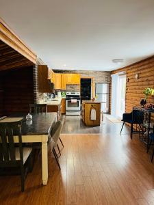 a kitchen with a table and a dining room at Casa Maria Irena in Meaford