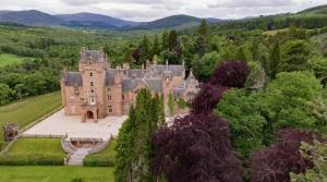 an old castle in the middle of a field at Delightful, central 3 bedroom house with garden. in Inverness