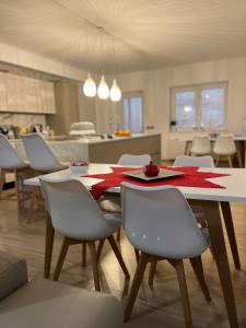 a dining room with a table and chairs and a kitchen at B&B La Terrazza in Cotronei