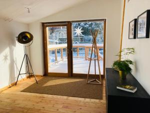 a room with a door with a view of a deck at ökologisch Wohnen im Grünen in Marburg an der Lahn