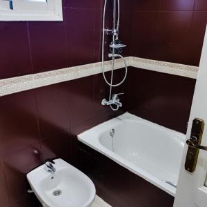 a bathroom with a shower and a sink and a tub at Beautiful Apartment in centre ville M2 in Tangier