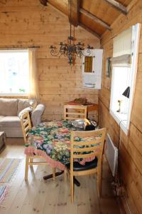 a dining room with a table and chairs in a cabin at Valen Cabins in Reine in Reine