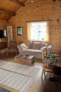 a living room with a couch and a coffee table at Valen Cabins in Reine in Reine