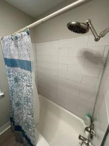 a bathroom with a shower curtain and a sink at Relaxing Bungalow in Cleveland