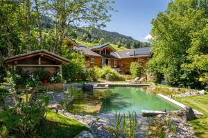 a house with a swimming pool in the yard at Das Talgut in Ofterschwang