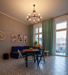 a living room with a blue couch and a table at Apartament u Olechny in Bydgoszcz
