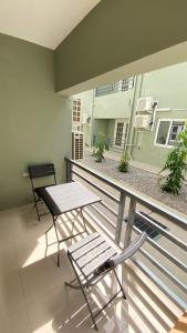a balcony with a table and a table and chairs at Serenity Condo in Piarco