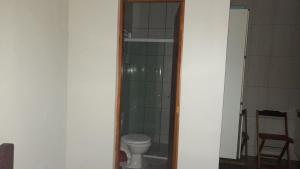 a bathroom with a toilet and a glass shower at Casa Paiol Grande in São Bento do Sapucaí +14 photos