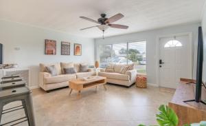a living room with two couches and a ceiling fan at Paradise Oasis with Heated Pool 8 mins from the Beach! in Pompano Beach