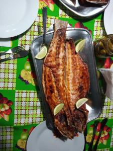 a pan with a piece of meat on a table at Kitnet da Elô in Tramandaí