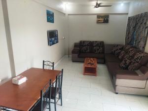 a living room with a couch and a table at Double bed in Nadi