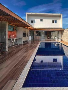 a house with a swimming pool in front of a house at Skyhouse in Boituva