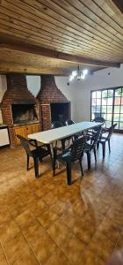 a large dining room with a large table and chairs at Matices Hostel Centro in El Calafate