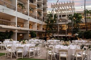 a banquet hall with white tables and chairs at Waikiki Beach Marriott Resort & Spa in Honolulu